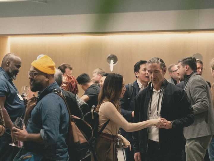 Guests talk and connect at a warmly lit business event