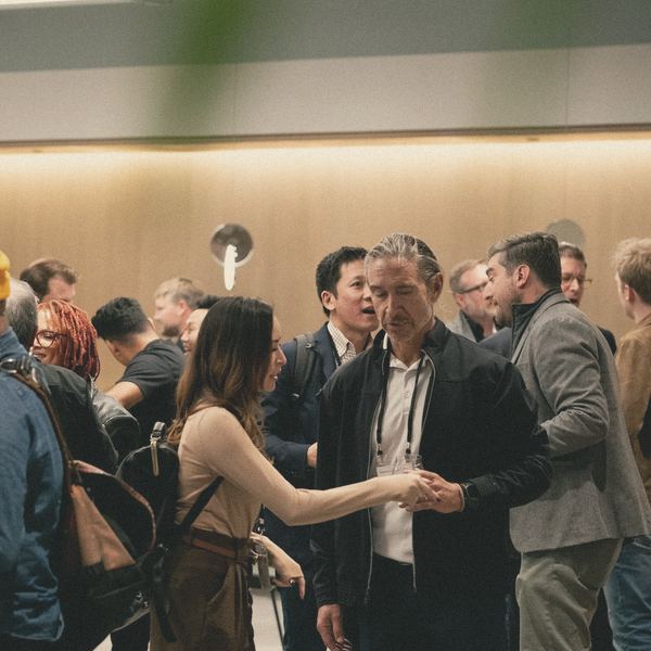 Guests talk and connect at a warmly lit business event
