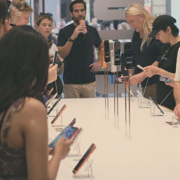 People try new phones at a launch table