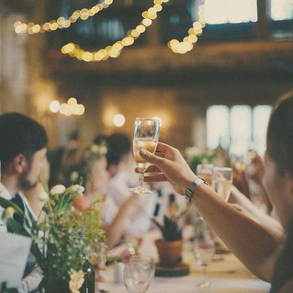 Guests raise their glasses at a candlelit dinner