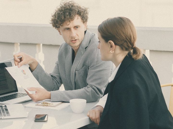 A consultant walks a client through a one-page proposal