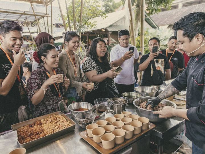 A crowd films a chef's live demo on their phones