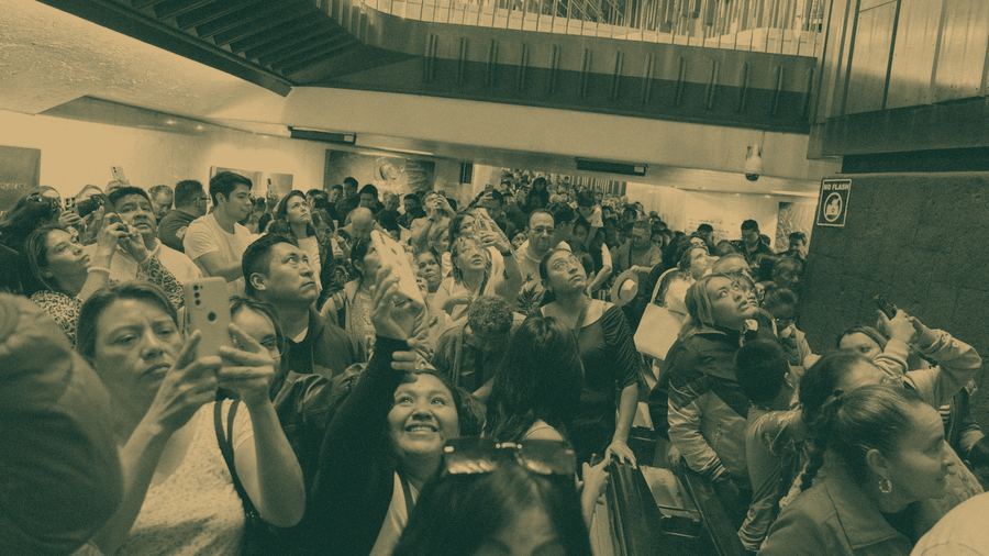 A crowd looks up in delight at a brand event